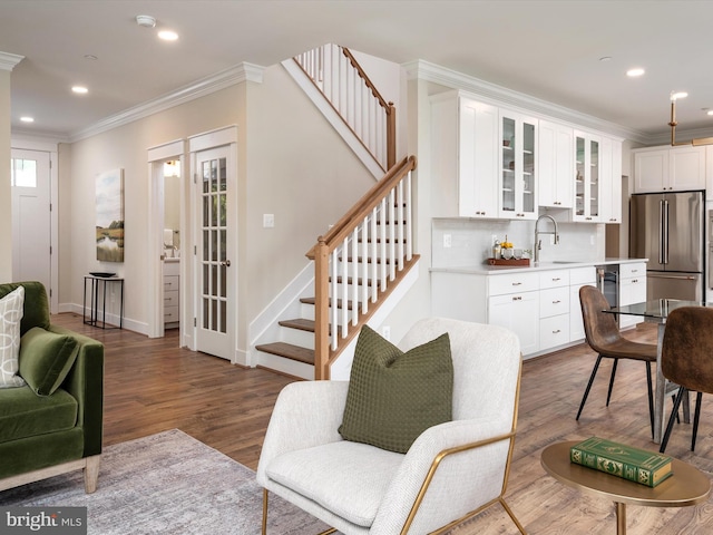 living room featuring baseboards, dark wood finished floors, stairs, ornamental molding, and recessed lighting