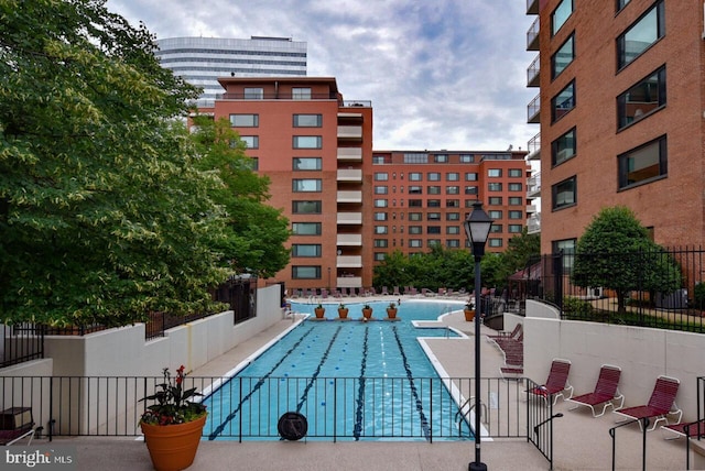 view of swimming pool featuring fence