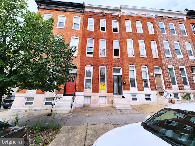 view of front of property with entry steps and brick siding