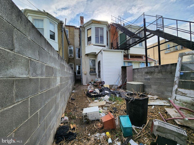 back of house featuring fence