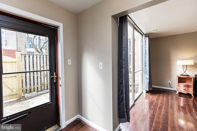 foyer entrance with wood finished floors and baseboards