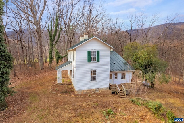 view of side of home featuring a chimney