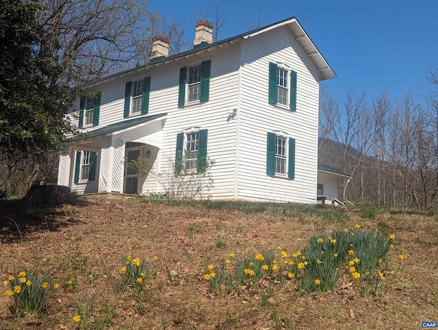 view of front of home featuring a chimney