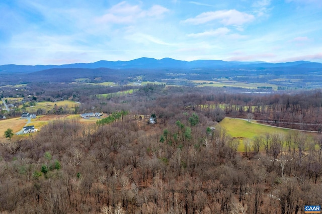 aerial view with a wooded view and a mountain view