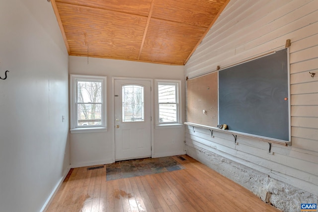 entryway with wood ceiling, a healthy amount of sunlight, vaulted ceiling, and hardwood / wood-style flooring