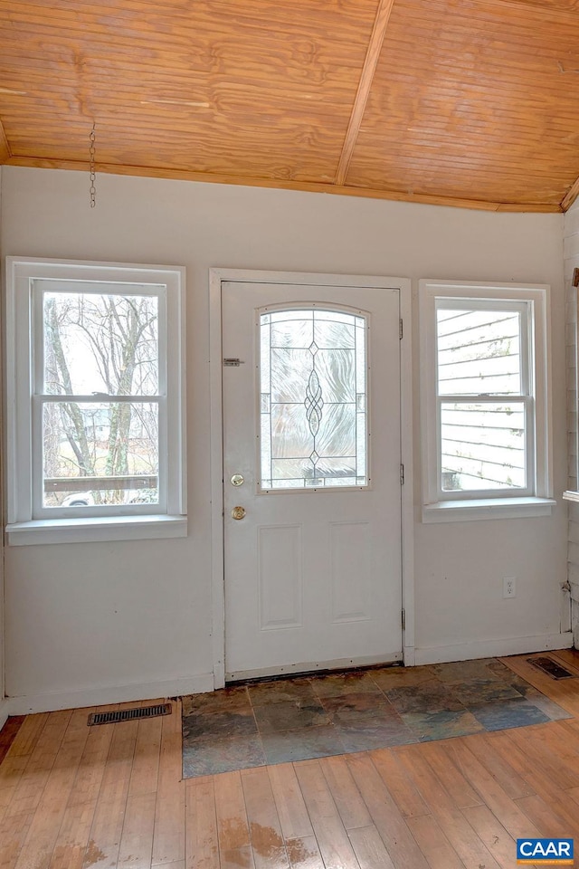 entryway with hardwood / wood-style flooring, wood ceiling, visible vents, and lofted ceiling