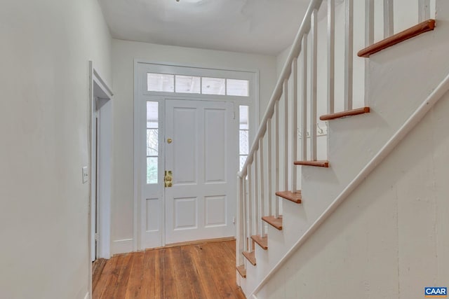 entryway featuring stairs and wood finished floors