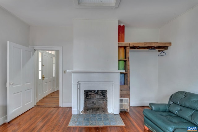 unfurnished living room featuring a fireplace, baseboards, and hardwood / wood-style floors