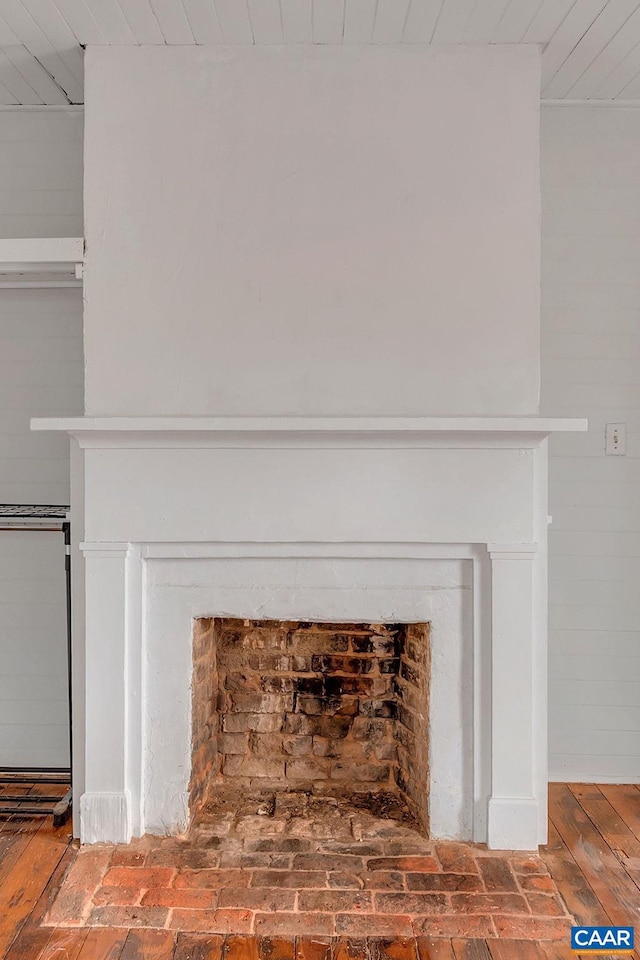 interior details featuring a fireplace with flush hearth and wooden ceiling