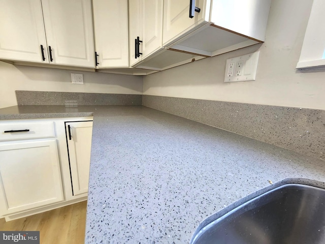 681 Fayette St, Cumberland, MD 21502 - room details featuring white cabinetry, wood finished floors, and a sink
