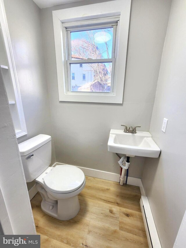 681 Fayette St, Cumberland, MD 21502 - bathroom featuring toilet, wood finished floors, baseboards, and baseboard heating