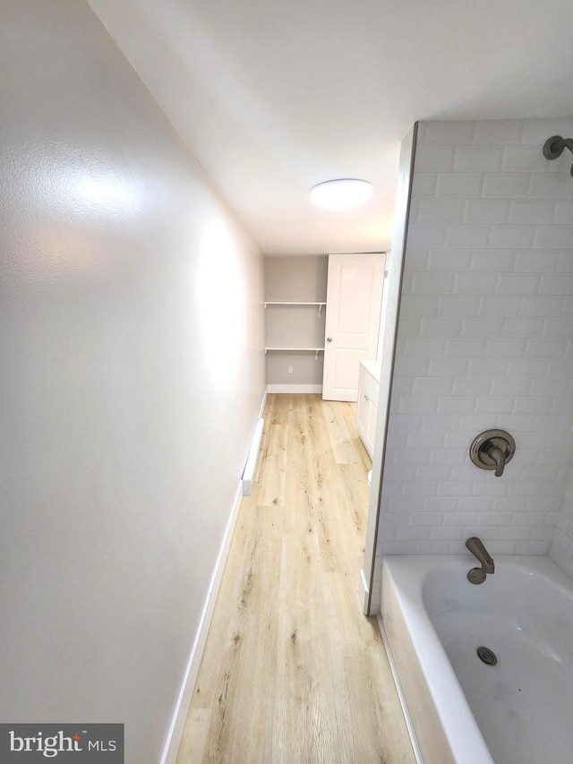 681 Fayette St, Cumberland, MD 21502 - bathroom with shower / bathtub combination, baseboards, and wood finished floors