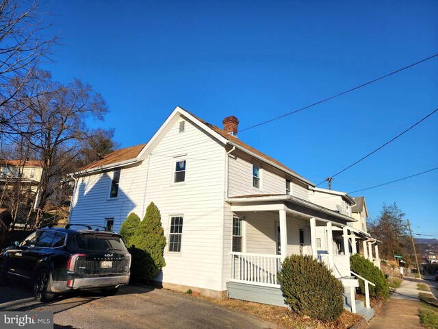 681 Fayette St, Cumberland, MD 21502 - view of side of property with a porch and a chimney
