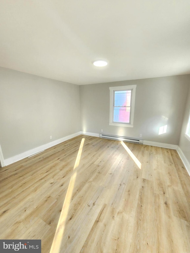 681 Fayette St, Cumberland, MD 21502 - empty room featuring light wood finished floors, baseboard heating, and baseboards