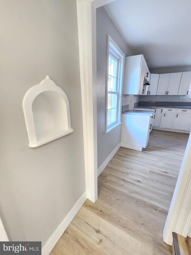 681 Fayette St, Cumberland, MD 21502 - kitchen featuring baseboards, white cabinets, and light wood finished floors