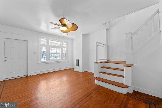 entrance foyer featuring stairs, baseboards, and wood finished floors