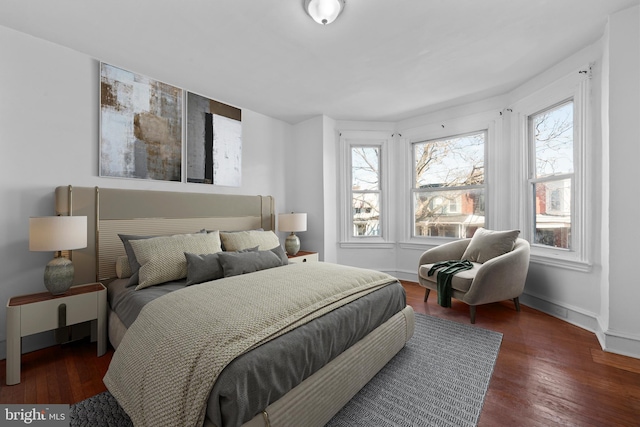 bedroom with wood finished floors and baseboards