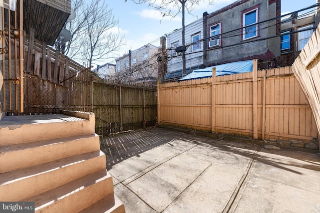 view of patio featuring fence