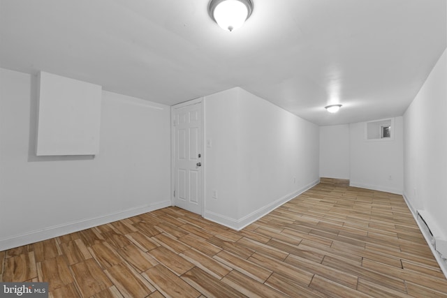 interior space featuring baseboards and wood finished floors