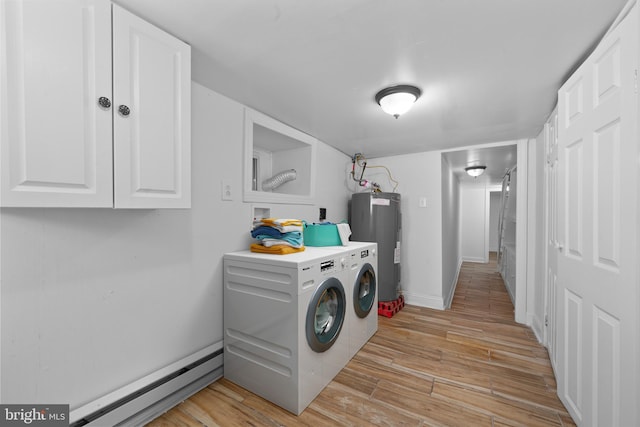 laundry room featuring electric water heater, baseboards, light wood-style floors, washer and dryer, and a baseboard radiator