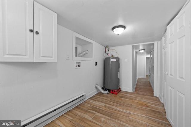 interior space featuring light wood-type flooring, a baseboard heating unit, baseboards, and water heater