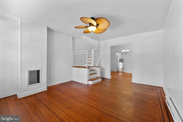 unfurnished living room featuring visible vents, a baseboard heating unit, baseboards, stairs, and hardwood / wood-style floors