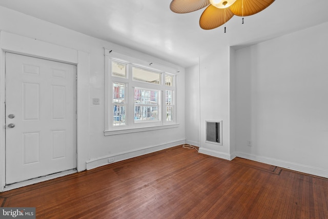 unfurnished living room with baseboards, visible vents, a fireplace, ceiling fan, and hardwood / wood-style flooring