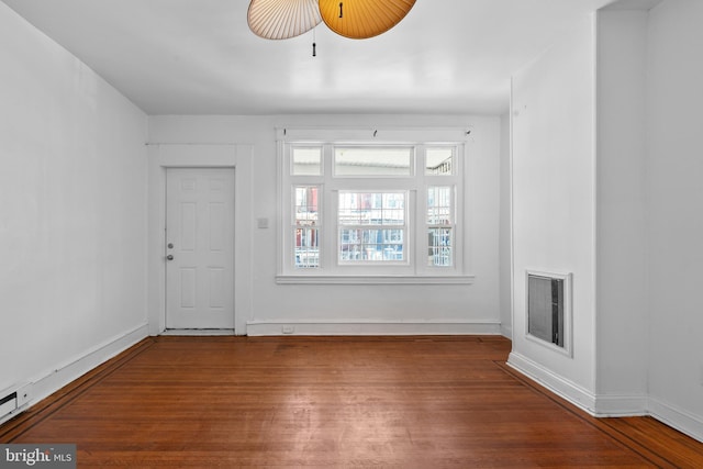 entrance foyer featuring visible vents, baseboards, and wood finished floors