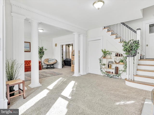 interior space featuring stairs and ornate columns