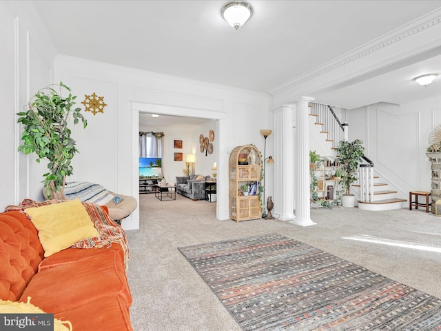 carpeted living room with stairs, crown molding, and a decorative wall