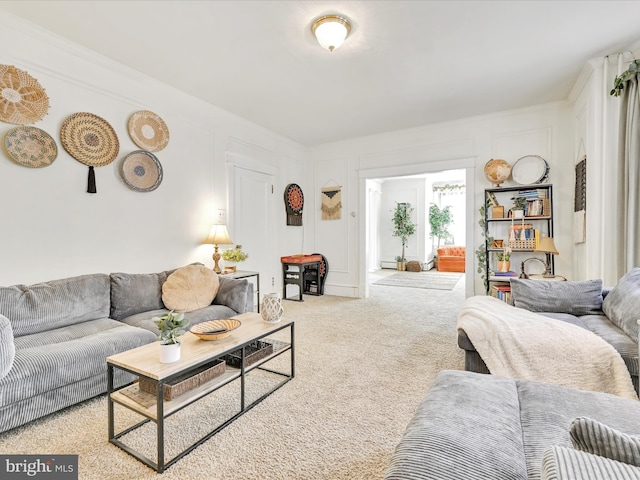 carpeted living area featuring crown molding and a decorative wall