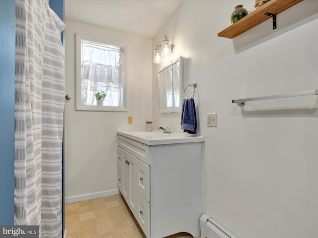 full bathroom featuring vanity, a baseboard heating unit, and baseboards