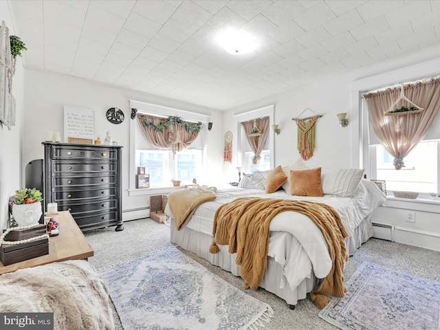 bedroom featuring multiple windows, baseboard heating, and carpet floors