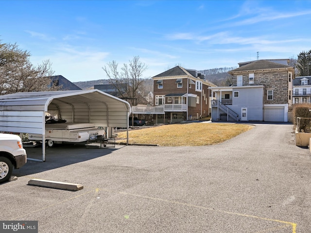 view of front of property featuring a carport and driveway