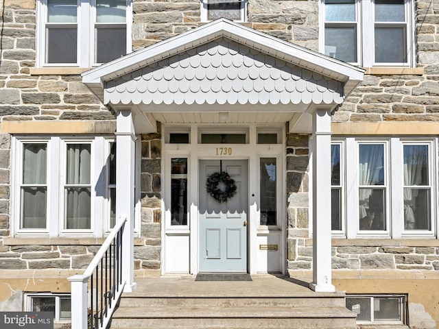 property entrance with stone siding