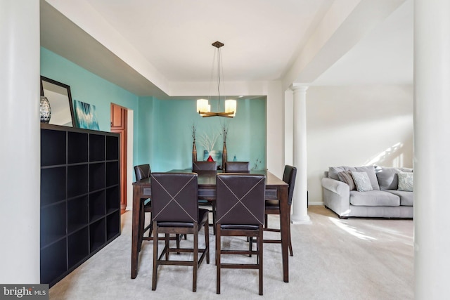 107 Persimmon Pl, Bear, DE 19701 - dining area featuring light colored carpet, an inviting chandelier, and ornate columns