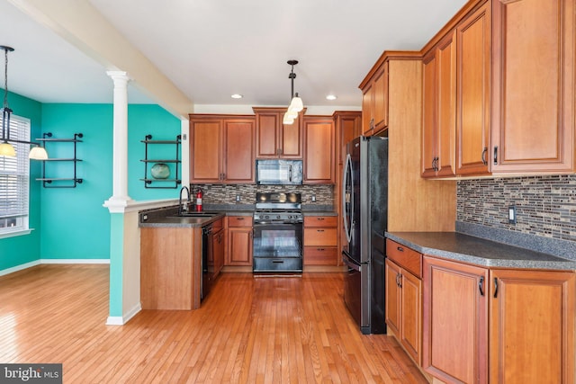 107 Persimmon Pl, Bear, DE 19701 - kitchen with decorative columns, brown cabinets, dark countertops, and black appliances