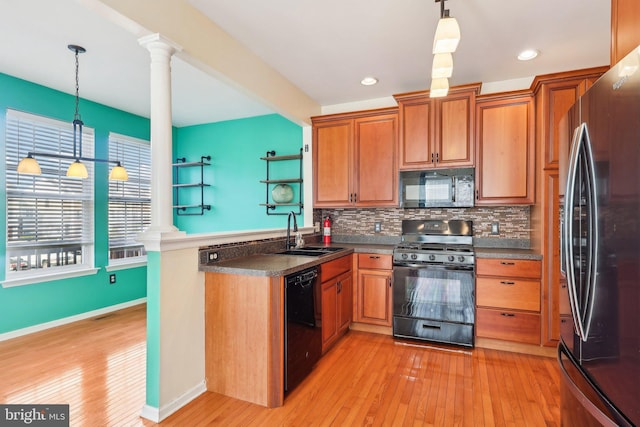 107 Persimmon Pl, Bear, DE 19701 - kitchen with a peninsula, a sink, black appliances, tasteful backsplash, and light wood-type flooring
