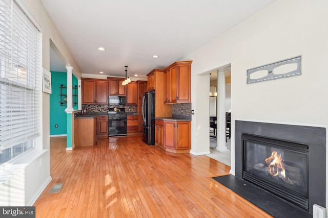 107 Persimmon Pl, Bear, DE 19701 - kitchen with black appliances, dark countertops, brown cabinetry, and visible vents