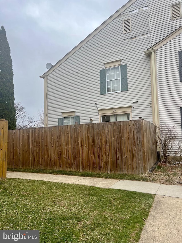 view of home's exterior featuring a yard and fence