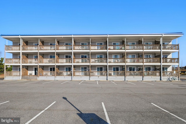 view of building exterior with uncovered parking