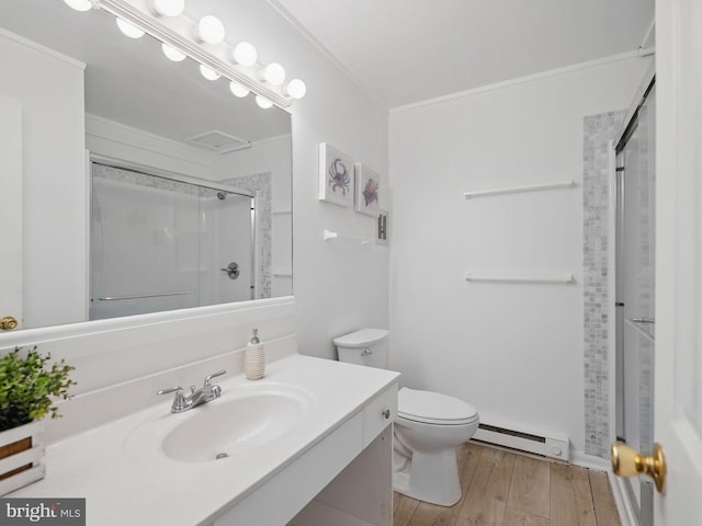 bathroom featuring an enclosed shower, ornamental molding, wood finished floors, baseboard heating, and vanity