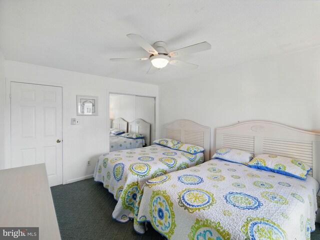 bedroom featuring baseboards, a closet, carpet floors, and ceiling fan