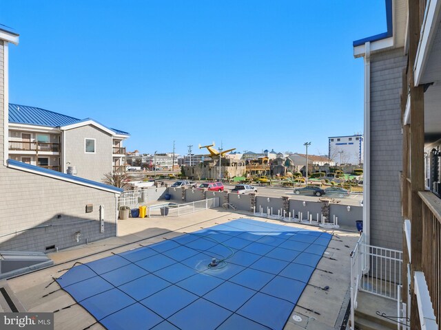 view of swimming pool featuring a patio and a residential view