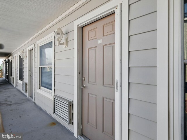 property entrance featuring visible vents and covered porch