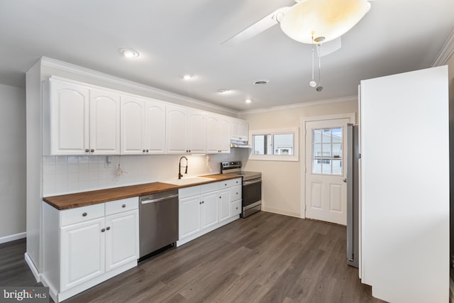 kitchen featuring decorative backsplash, appliances with stainless steel finishes, dark wood-style floors, wood counters, and a sink