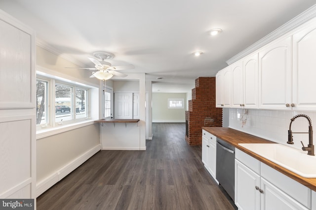 kitchen with a sink, white cabinets, a baseboard radiator, and stainless steel dishwasher