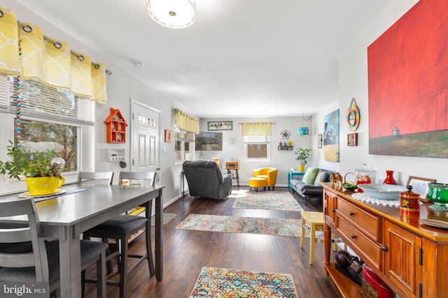 dining area with baseboards and dark wood-style flooring