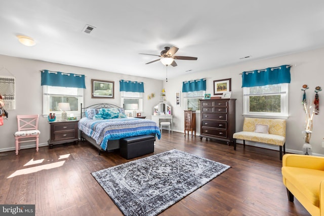 bedroom featuring baseboards, visible vents, and wood-type flooring