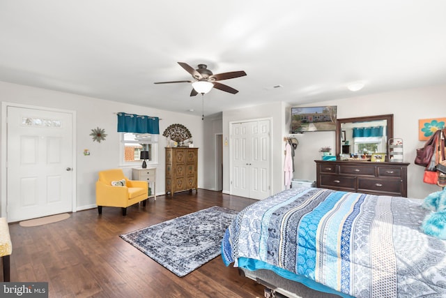 bedroom featuring a ceiling fan, wood finished floors, visible vents, and a closet